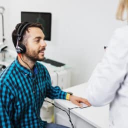 Smiling man in a hearing test