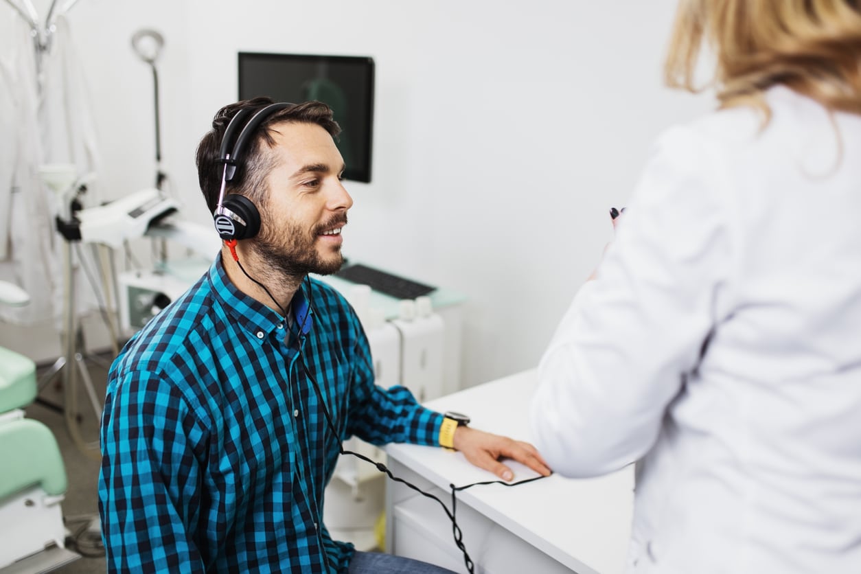 Smiling man in a hearing test