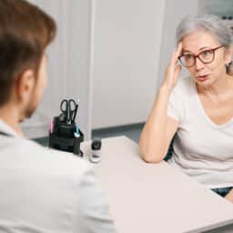 Patient explaining tinnitus to her provider