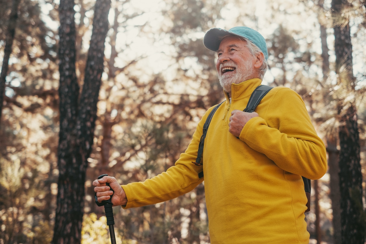 Happy senior man on a hike.