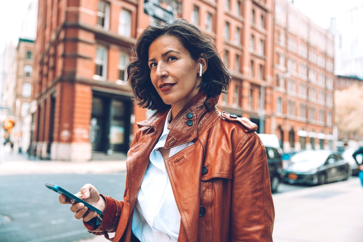 Woman wears airpods through the city