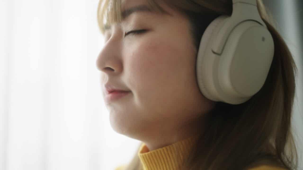 Woman in good mood listens to music.