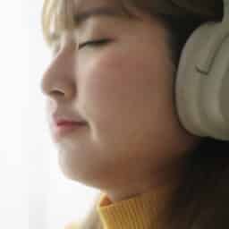 Woman in good mood listens to music