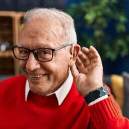 Happy man with hearing aid