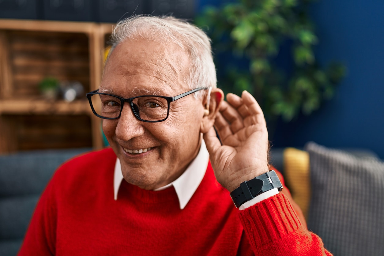Happy man with hearing aid