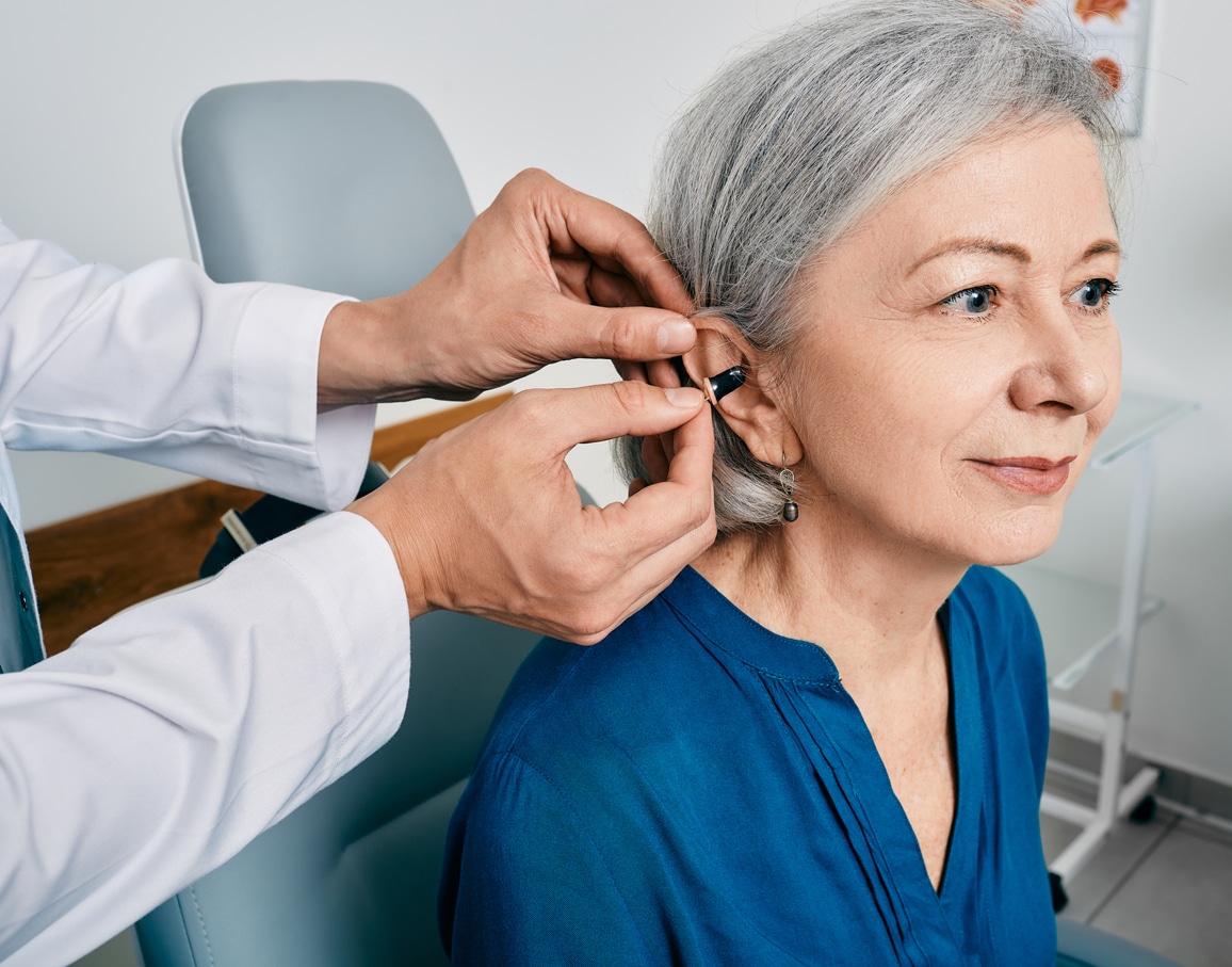 Woman at a hearing aid fitting appointment for her new hearing aids. 