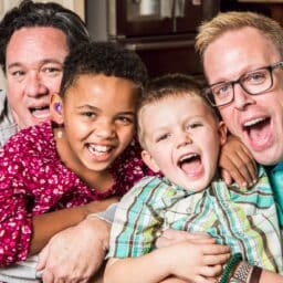 Happy family celebrates the new year. One of the children wears hearing aids.