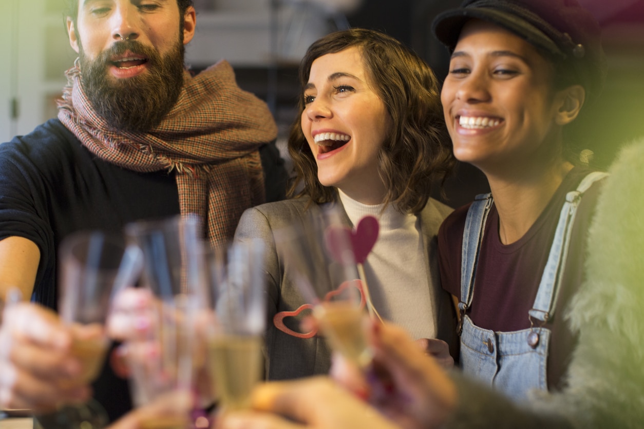 Group of happy friends toasting and drinking champagne.