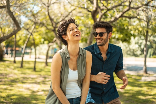 Two friends hanging out in a park on a warm, humid spring day