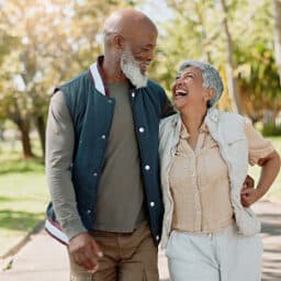 Happy couple taking a walk in a park on a beautiful spring day.