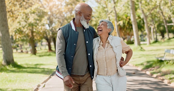 Happy couple taking a walk in a park on a beautiful spring day.