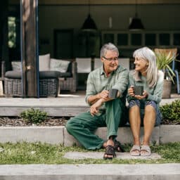 Happy couple drinking their coffee outside, enjoying the moment.