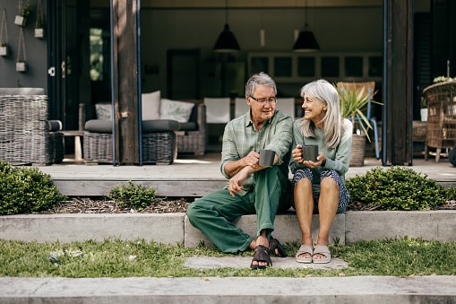 Happy couple drinking their coffee outside, enjoying the moment.