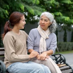 Grandmother and granddaughter having a nice productive conversation in a park.