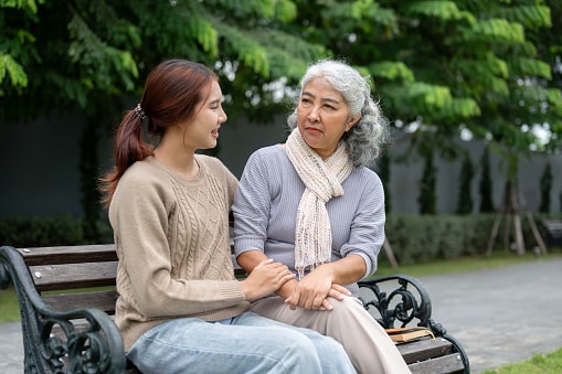 Grandmother and granddaughter having a nice productive conversation in a park.