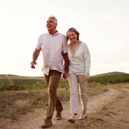 Happy, healthy couple taking a long walk together on a beautiful evening.