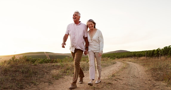Happy, healthy couple taking a long walk together on a beautiful evening.